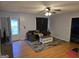 Well-lit living room with hardwood floors, neutral walls, and a plush sofa at 220 Joe Dr, Temple, GA 30179