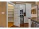 View of the kitchen pantry with shelving and stainless steel appliances at 318 Turner Cir, Mcdonough, GA 30252