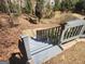 View of backyard steps and tiered retaining walls leading up to a home at 718 Avalon Way, Peachtree City, GA 30269