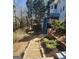 Backyard showing staircases to a deck and tiered retaining walls with landscaping at 718 Avalon Way, Peachtree City, GA 30269