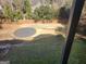 Expansive backyard with mature trees and established circular gravel feature, great for entertaining at 718 Avalon Way, Peachtree City, GA 30269