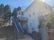 Backyard view of an elevated deck with stairs leading down to the lower levels at 718 Avalon Way, Peachtree City, GA 30269