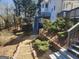 Backyard with retaining walls, landscaping, and exterior stairs to the deck and home at 718 Avalon Way, Peachtree City, GA 30269