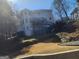 Backyard view of a multi-level deck and landscaped yard with retaining wall at 718 Avalon Way, Peachtree City, GA 30269