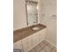 Bathroom sink featuring granite countertops, tile floors, white cabinets, and a decorative mirror at 718 Avalon Way, Peachtree City, GA 30269