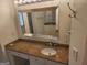 Granite vanity in bathroom features an oversized mirror and updated fixtures at 718 Avalon Way, Peachtree City, GA 30269
