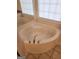 Bathroom featuring a corner soaking tub with tile flooring, window, and white cabinets at 718 Avalon Way, Peachtree City, GA 30269