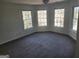 Inviting bedroom featuring neutral paint, plush carpet, and multiple windows allowing for natural light at 718 Avalon Way, Peachtree City, GA 30269