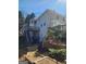 Exterior of home with tiered decks, patios, landscaped grounds, and backyard access at 718 Avalon Way, Peachtree City, GA 30269
