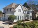 Stunning traditional-style home boasts pristine landscaping, dark shutters, and stone accents at 718 Avalon Way, Peachtree City, GA 30269