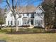 Traditional two-story home with a well-manicured front lawn and stone accents at 718 Avalon Way, Peachtree City, GA 30269