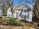 Charming two-story home with stone accents and inviting front yard landscaping and black shutters at 718 Avalon Way, Peachtree City, GA 30269