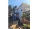 Back exterior view of the home with a deck and staircase from the backyard at 718 Avalon Way, Peachtree City, GA 30269