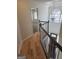 Hallway with wood floors overlooks the foyer with a chandelier and a large window at 718 Avalon Way, Peachtree City, GA 30269