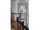 Foyer featuring a modern chandelier, hardwood floors, and a large window at 718 Avalon Way, Peachtree City, GA 30269
