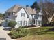 Stunning traditional-style home boasts pristine landscaping, dark shutters, and stone accents at 718 Avalon Way, Peachtree City, GA 30269