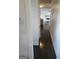Hallway view that leads to living room, showing hardwood floors and bright walls at 718 Avalon Way, Peachtree City, GA 30269