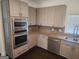 Gorgeous kitchen featuring granite countertops, stainless steel appliances, and light wood cabinets at 718 Avalon Way, Peachtree City, GA 30269