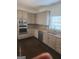 Well-equipped kitchen boasts modern appliances, granite countertops, and ample cabinetry at 718 Avalon Way, Peachtree City, GA 30269
