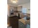 Open kitchen has stainless appliances, wood cabinets, granite counters and view to breakfast area at 718 Avalon Way, Peachtree City, GA 30269