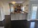 Bright kitchen with wooden floors, granite countertops, and modern appliances at 718 Avalon Way, Peachtree City, GA 30269
