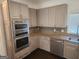 Stylish kitchen with stainless steel microwave and oven with granite countertops and wood cabinets at 718 Avalon Way, Peachtree City, GA 30269