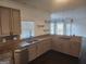 Well-lit kitchen features stainless steel appliances, granite countertops, and a sink with a window view at 718 Avalon Way, Peachtree City, GA 30269