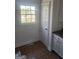 Clean room with tile floors, a window looking out on the trees, and a white door at 718 Avalon Way, Peachtree City, GA 30269