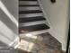 Stairway features stained stairs, white risers, and stone-look flooring at 718 Avalon Way, Peachtree City, GA 30269