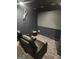 Home theater boasts plush reclining seating, carpet, and large screen for an immersive viewing experience at 718 Avalon Way, Peachtree City, GA 30269
