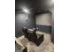 Home theater boasts plush reclining seating, carpet, and large screen for an immersive viewing experience at 718 Avalon Way, Peachtree City, GA 30269
