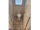 Bathroom features a toilet with tiled flooring, and access door at 718 Avalon Way, Peachtree City, GA 30269