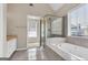 Bright bathroom featuring a glass-enclosed shower and a soaking tub at 3685 Washington Rd, East Point, GA 30344