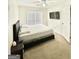 Bright bedroom features a queen bed, ceiling fan and mounted flat-screen TV at 3685 Washington Rd, East Point, GA 30344