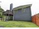 Back exterior of a blue two-story home with a deck and small patio at 3685 Washington Rd, East Point, GA 30344