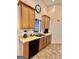 Well-lit kitchen with tan cabinetry, dishwasher, and a stainless steel sink at 3685 Washington Rd, East Point, GA 30344