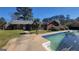 Backyard with a brick house, in-ground pool, and nice trees at 1083 Hampton Rd, Hampton, GA 30228