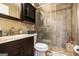 Bathroom with a shower featuring tiled walls, a toilet, and a sink at 1083 Hampton Rd, Hampton, GA 30228