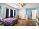 Bright blue bedroom with a galaxy-themed bed and hardwood floors at 1083 Hampton Rd, Hampton, GA 30228