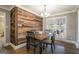 Dining room featuring a rustic accent wall and a view to the outdoors at 1083 Hampton Rd, Hampton, GA 30228