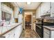 Galley kitchen with white cabinets, tile countertops, and stainless steel oven at 1083 Hampton Rd, Hampton, GA 30228