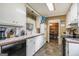Kitchen featuring white cabinets, tile backsplash, and black dishwasher at 1083 Hampton Rd, Hampton, GA 30228