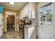 Kitchen with white cabinets, access door, and view to the backyard pool at 1083 Hampton Rd, Hampton, GA 30228