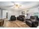 Cozy living room with wood flooring, a ceiling fan, and comfortable furnishings at 1083 Hampton Rd, Hampton, GA 30228
