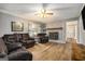 Comfortable living room featuring a fireplace, wood floors, and lots of seating at 1083 Hampton Rd, Hampton, GA 30228