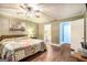 Main bedroom featuring a bed, ceiling fan, and connected bathroom at 1083 Hampton Rd, Hampton, GA 30228