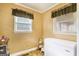 Small room with two windows and an upright freezer against the wall at 1083 Hampton Rd, Hampton, GA 30228