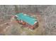 Aerial view showing a brick home with a green roof and a rear deck at 81 Bowers Rd, Moreland, GA 30259