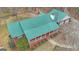 Aerial view of a brick home with a metal roof, front porch, and attached garage at 81 Bowers Rd, Moreland, GA 30259