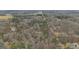 An aerial view showing the wooded land and surrounding area of the property at 81 Bowers Rd, Moreland, GA 30259